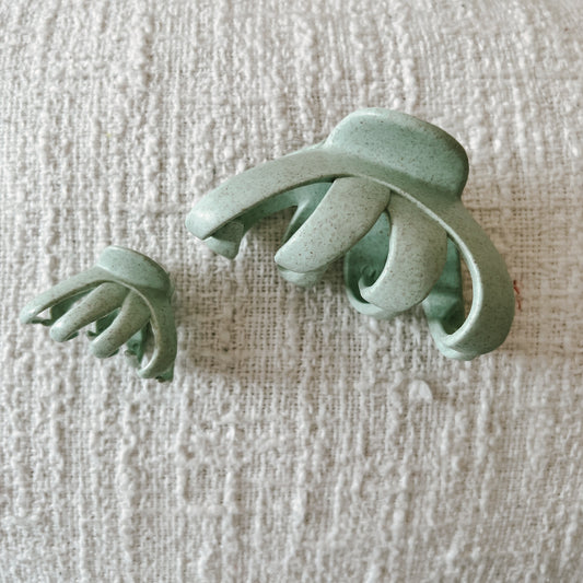 Green octopus clip in wheat straw